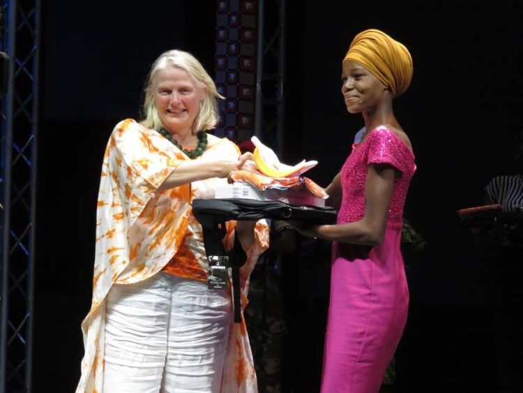 La lauréate Emmanuela e Sorgho en train de recevoir sa récompense cpù^psée de La lauréate Emmanuela e Sorghon train de recevoir sa récompense, un trophée; une tablette, des fournitures, ....